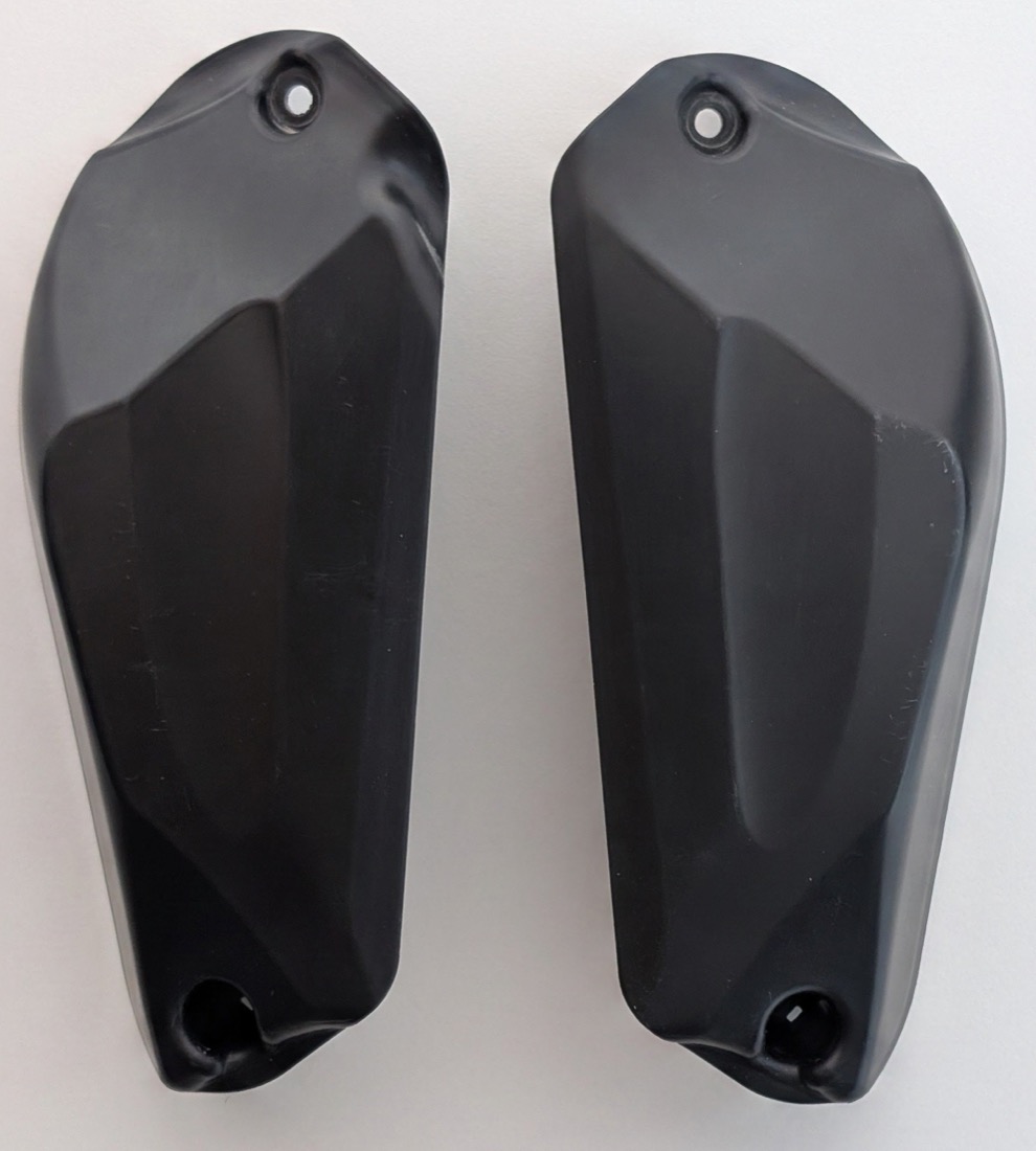 The original closed BMW OEM airbox intake covers for the R 1300 GS / GSA, a matching left and right pair in black plastic.