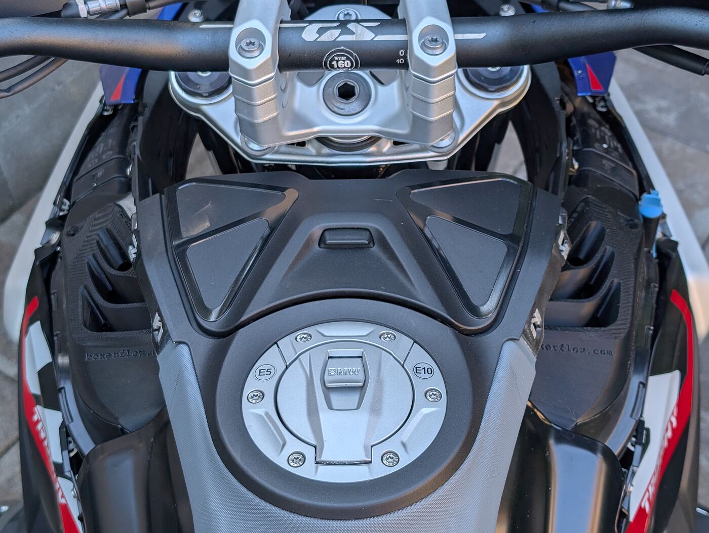 Both BoxerFlow Rally Intake covers fitted to a BMW R 1300 GS, seen from the saddle looking forward over the fuel tank and GS handlebar.