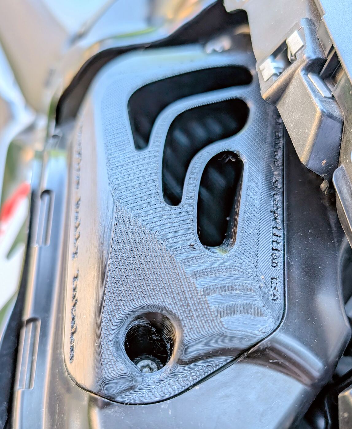 A single BoxerFlow Rally Intake cover bolted to the airbox of a BMW R 1300 GS, showing the mounting hole and the OEM fixing point.